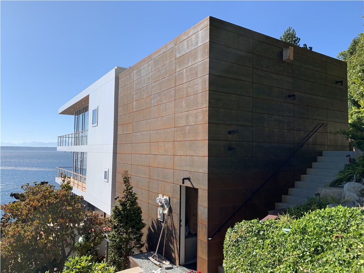 House with metal siding made or corten steel facing the water