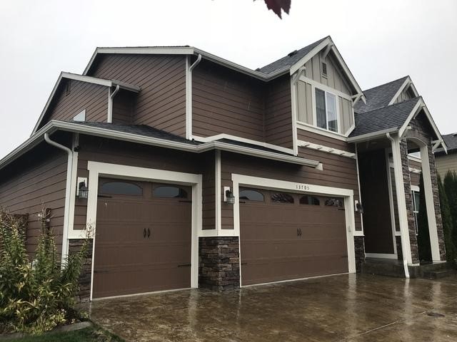 Cloudy weather with a cool brown home's siding and garage color.
