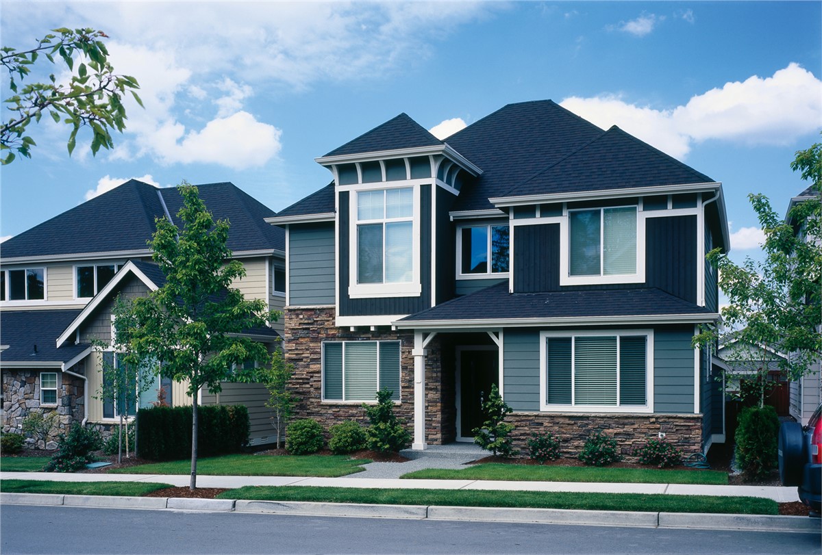 Home with a tree in the front with James Hardie siding.