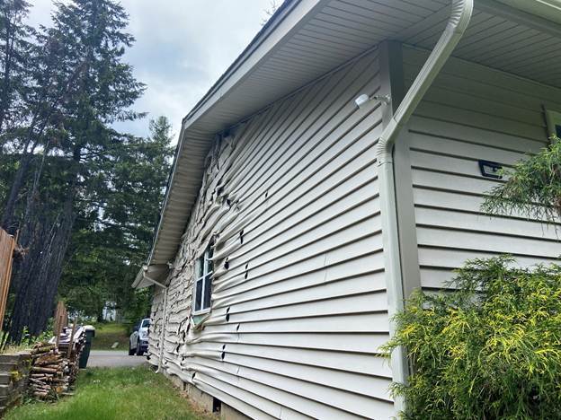 Warped-and-peeling-vinyl-siding