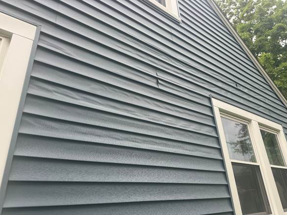 Warped-vinyl-siding-heat-damage
