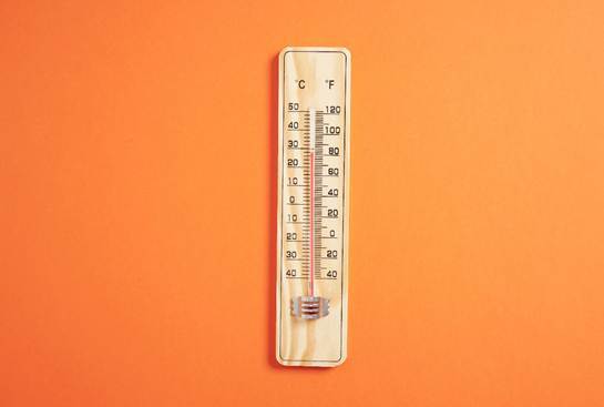 Thermostat-on-orange-wall