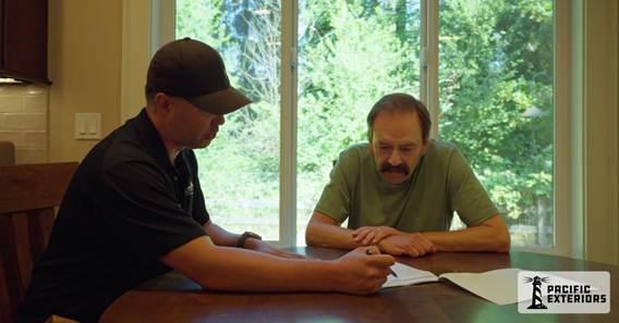 Pacific-Exteriors-estimator-walking-with-homeowner