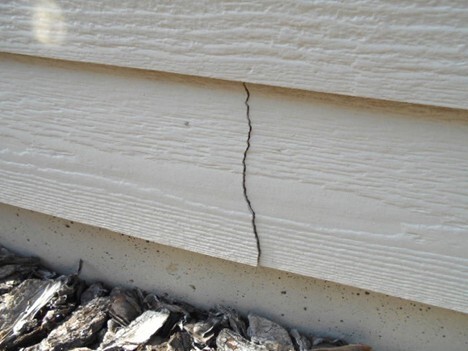 Prominent crack in fiber cement siding.